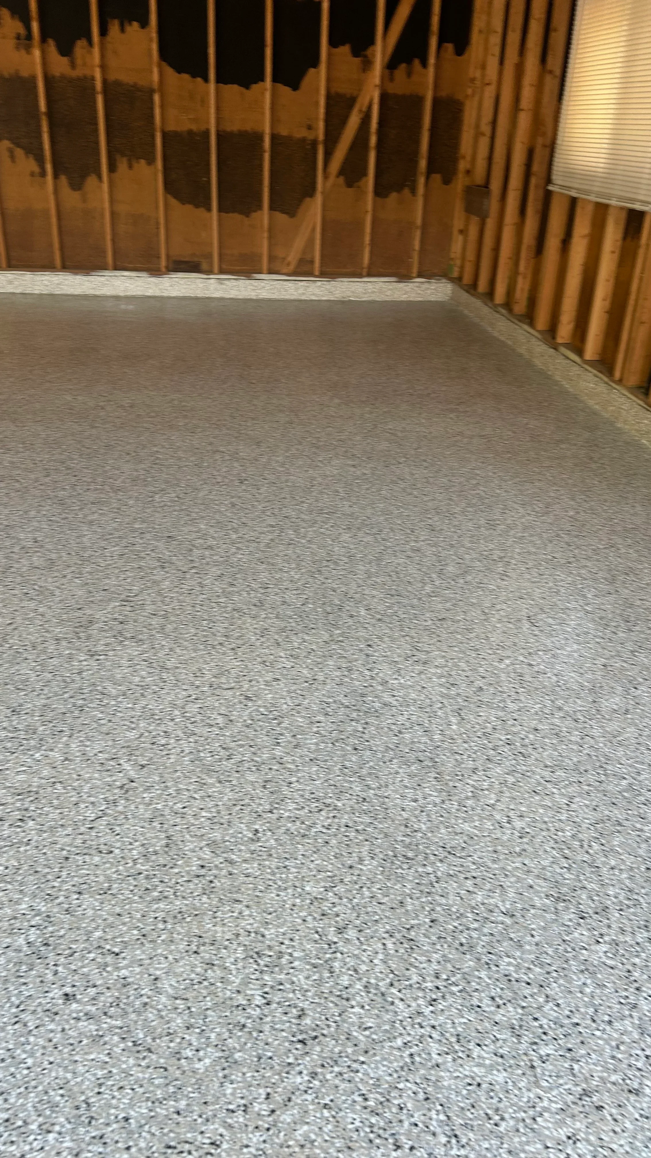 Polished concrete floor with light gray aggregate finish and clean edge detail