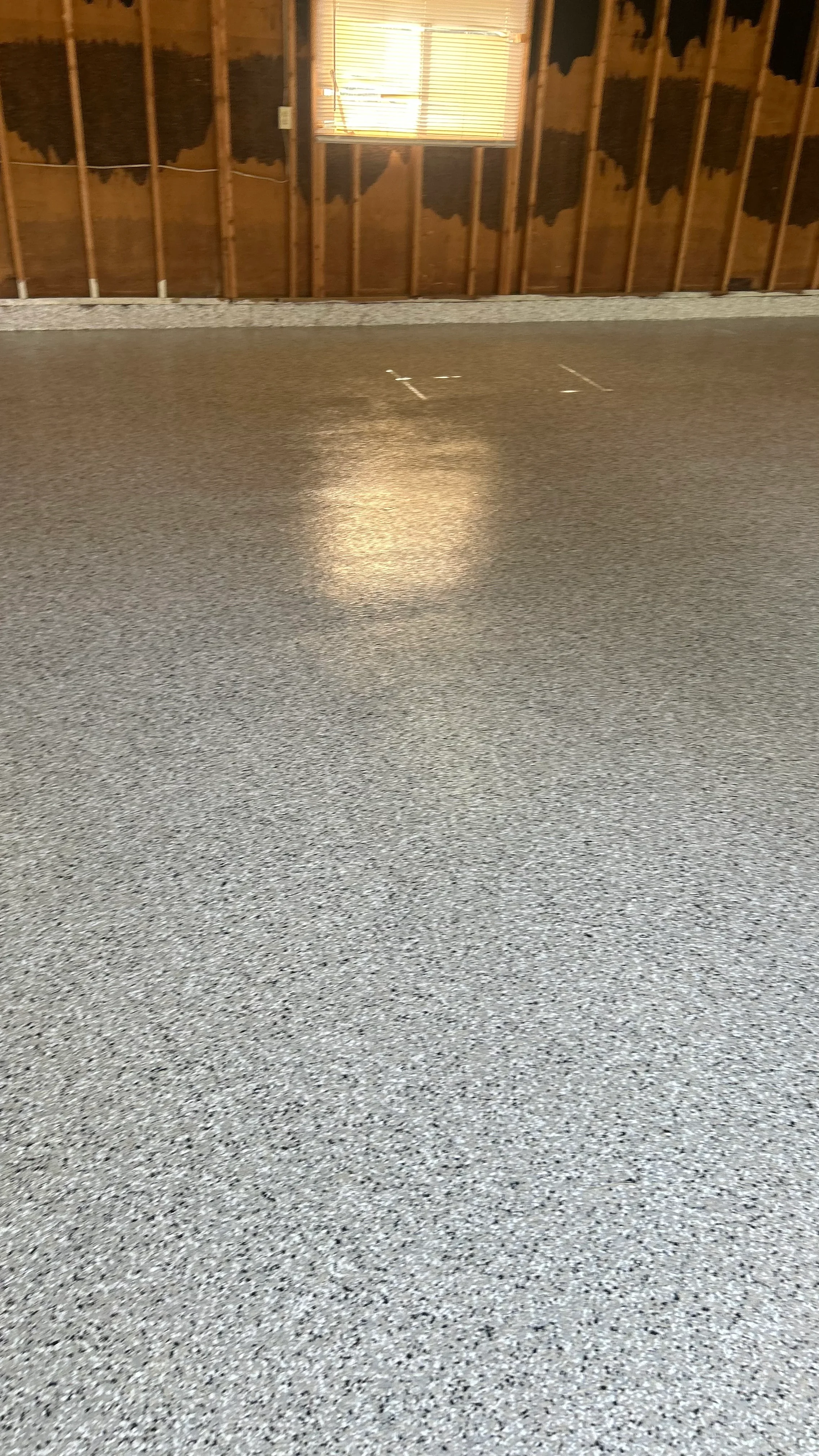 Polished concrete floor with reflective finish and uniform gray aggregate surface
