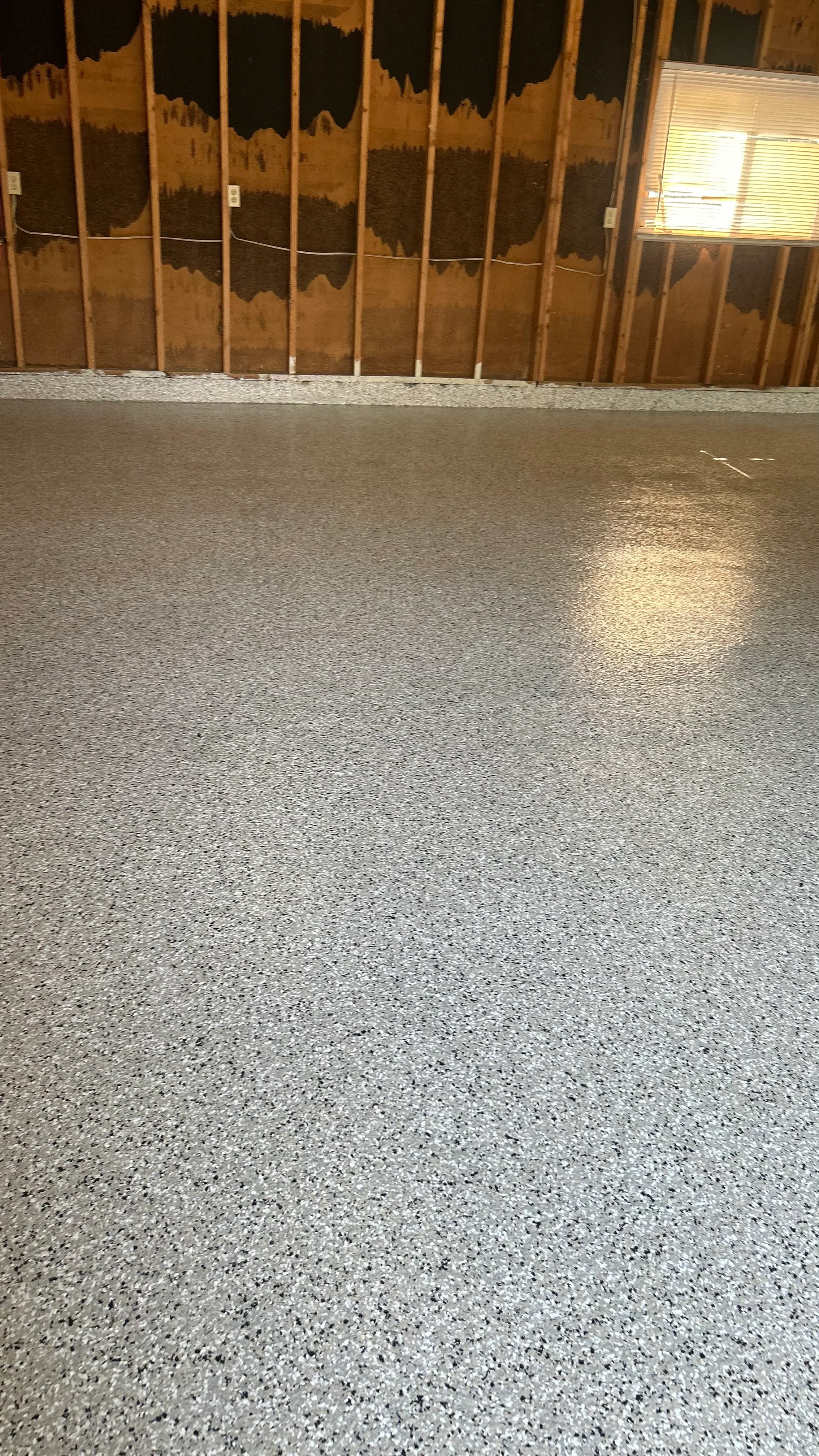 Polished concrete floor with light gray aggregate and high-gloss finish