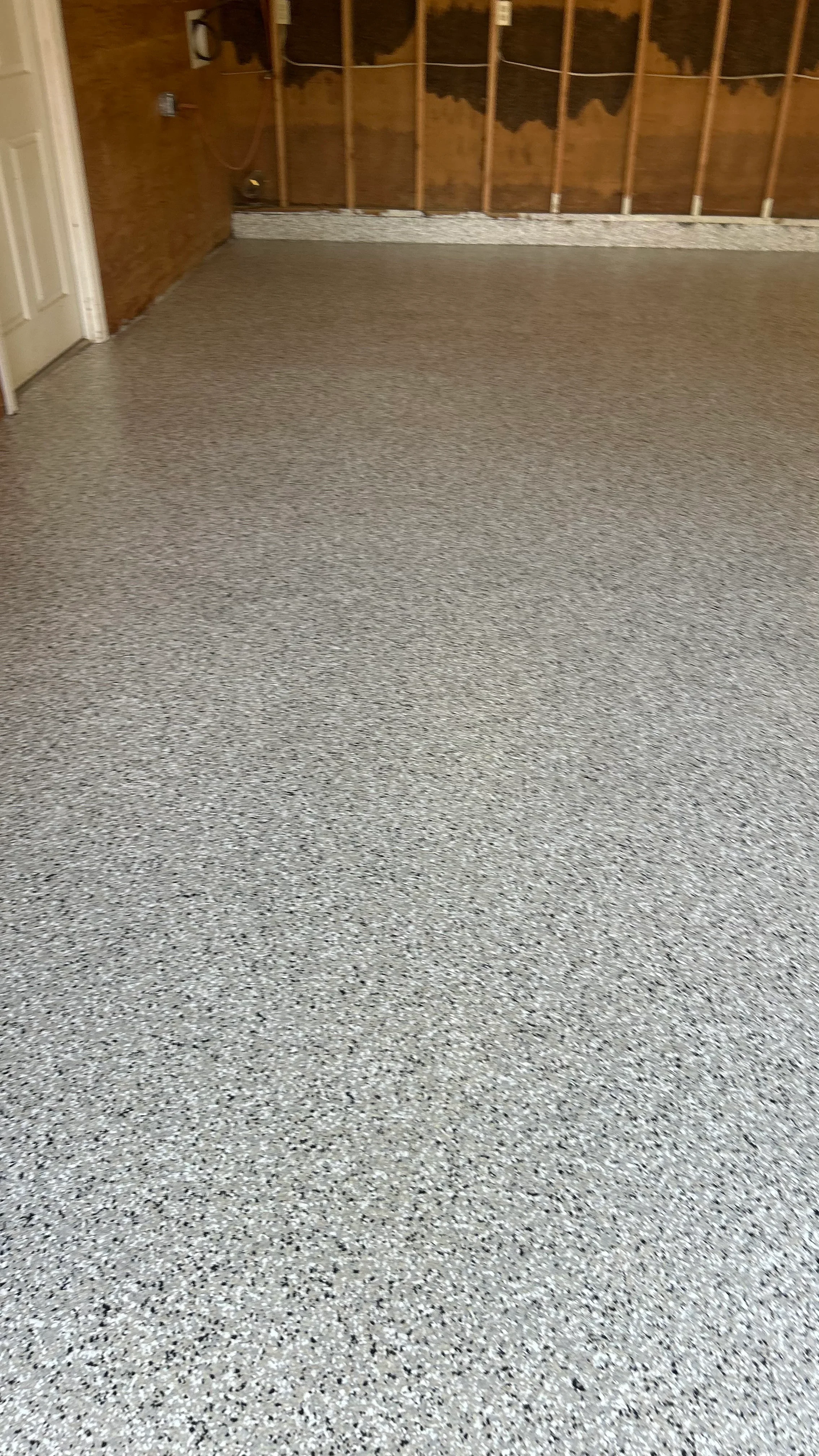 Polished concrete floor with light gray aggregate and sealed finish in interior space